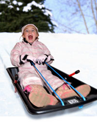 Child sledging down hill