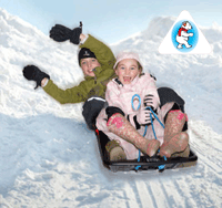 Adult and child sledging down hill